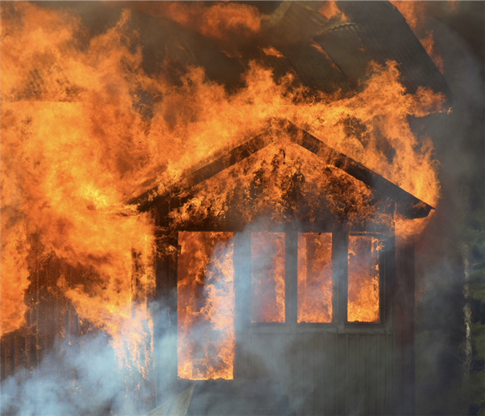 Flames engulfing a house. 